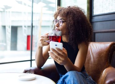 beautiful-young-woman-drinking-coffee-in-cafe-VMBEPXH.jpg